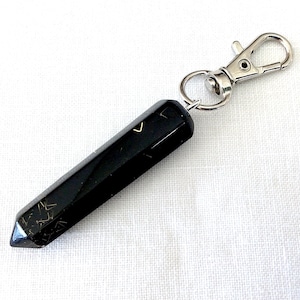 May include: Black obsidian crystal point keychain with gold flecks and a silver metal clasp.