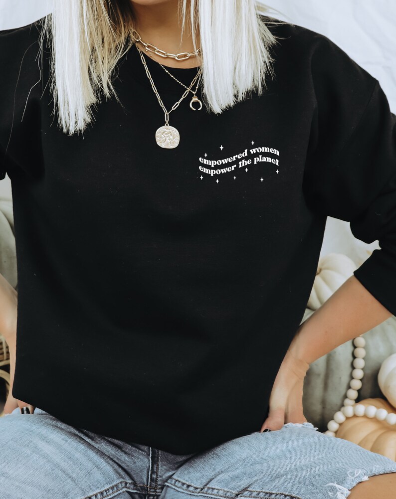 May include: Black sweatshirt with the text "empowered women empower the planet" in white lettering.