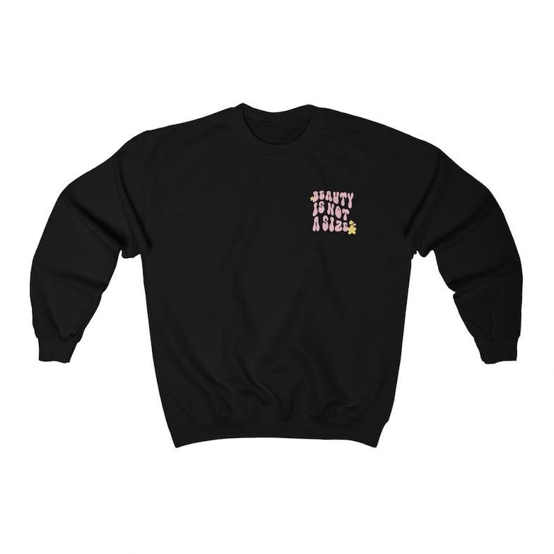 May include: Black sweatshirt with the text "BEAUTY IS NOT A SIZE" in pink letters with yellow flower accents.