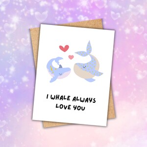 May include: A white card with two blue whales with yellow polka dots facing each other. The whales are surrounded by red hearts. The text on the card reads "I whale always love you".