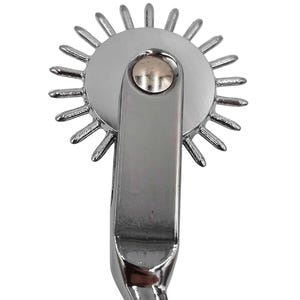 May include: A chrome-plated pinwheel tool with a circular head featuring radiating spikes. The handle is curved and polished, and the tool is designed for specific applications. The overall design is sleek and modern.