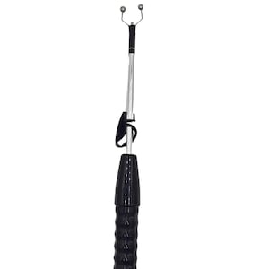 May include: A black and silver device with a textured handle and two small, spherical attachments at the top. The device has a strap and a cord extending from the bottom. The background is plain white.