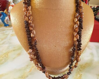 Beads 1970s, long single strand. Goes around neck twice. Small brown sea shells and dark brown seeds.