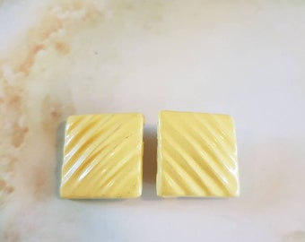 Earings 1960's clip on. Lemon colored rippled lucite, in a square shape.