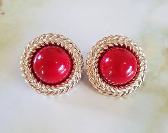 Earings, 1980's clip on.  Ornate goldtone framing a red acrylic centre.