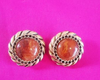 Earings, 1980's clip on.  Ornate goldtone framing a faux amber centre.