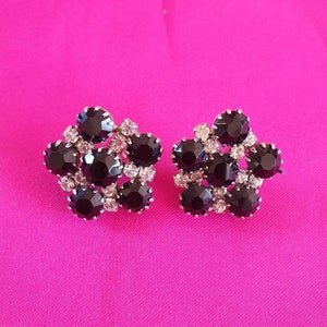 Earings 1980s pierced. Silvertone adorned with claw set, faceted black glass jewels and diamantes.