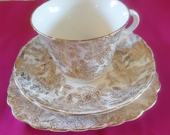 Tea cup set, 1940s. Colclough, genuine bone china, made in England. White china with a gold floral pattern.