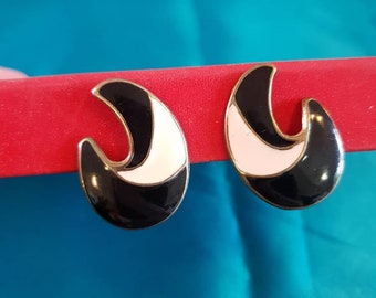 Earings 1980's clip on.  Goldtone in an abstract shape, adorned with black and white enamel work.