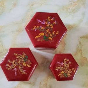 Trinket boxes/containers 1970. Made in Hong Kong. Reddish brown lucite with floral design on lids. All pack into large container. Set of 3.