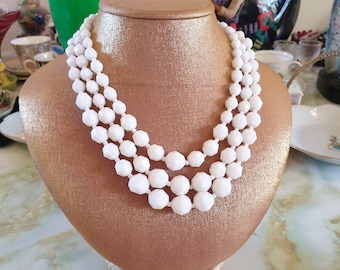 Beaded necklace 1950s. 3 strands of white, faceted, acrylic beads. Made in Hong Kong.