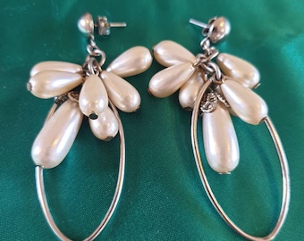 Earings 1970s pierced. Long faux pearls in a cluster chandelier design, atop silvertone in an oval shape.