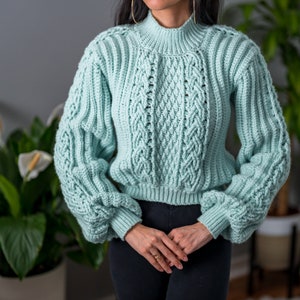 TCDDIY crochet pattern for a cropped cable stitch sweater with a mock neck and alpine stitch detailing, crafted using Caron One Pound yarn in Pale Green.