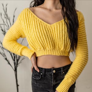 TCDDIY crochet pattern for a cropped off-the-shoulder V-neck sweater with versatile styling options, made with Lion Brand Pound of Love yarn in Honey Bee.