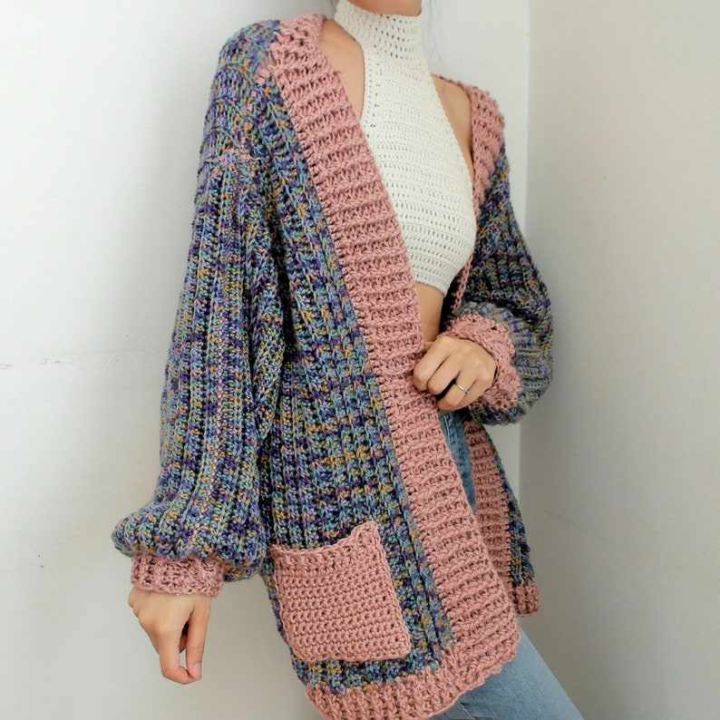 TCDDIY crochet pattern for an Oversized Reversible Cardigan featuring a ribbed two-toned design and pockets.