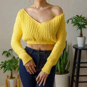 TCDDIY crochet pattern for a cropped off-the-shoulder V-neck sweater with versatile styling options, made with Lion Brand Pound of Love yarn in Honey Bee.