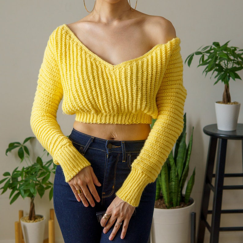TCDDIY crochet pattern for a cropped off-the-shoulder V-neck sweater with versatile styling options, made with Lion Brand Pound of Love yarn in Honey Bee.