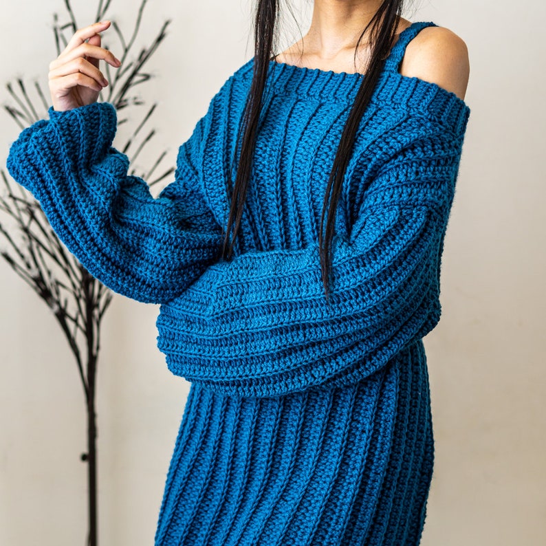 TCDDIY crochet pattern for a single strap sweater dress featuring balloon sleeves and a customizable length, crafted using Caron One Pound yarn in Ocean.