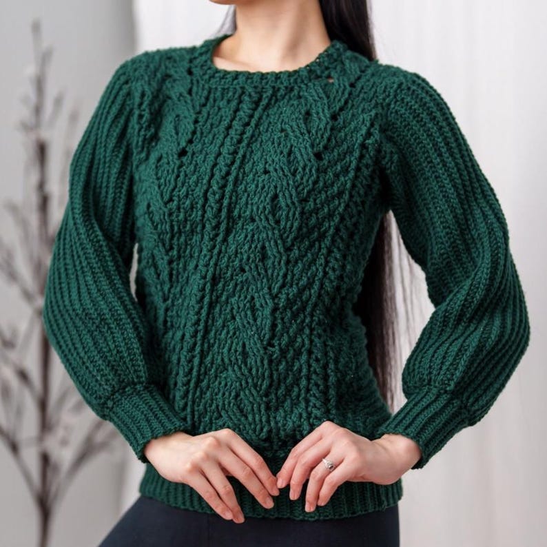 TCDDIY crochet pattern for a classic cropped crewneck sweater featuring cable and alpine stitches with ribbing details, made using Big Twist Soft yarn in Hunter Green.