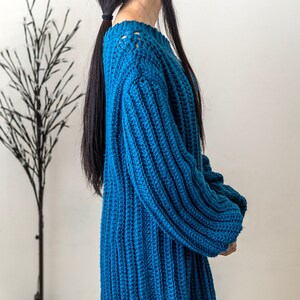 TCDDIY crochet pattern for a single strap sweater dress featuring balloon sleeves and a customizable length, crafted using Caron One Pound yarn in Ocean, side view.