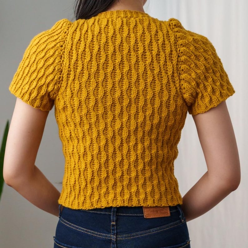 TCDDIY crochet pattern for a modern short sleeve crew neck t-shirt with almond stitch detail, crafted using Lion Brand Pound of Love yarn in Maize, back view.