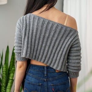 TCDDIY crochet pattern for an Off-the-Shoulder Cropped Sweater with short sleeves, ribbing, and open hem design, crafted with Lion Brand Pound of Love in Oxford Grey, back view.