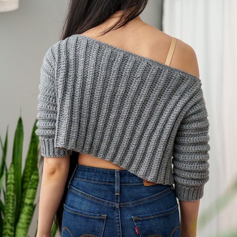 TCDDIY crochet pattern for an Off-the-Shoulder Cropped Sweater with short sleeves, ribbing, and open hem design, crafted with Lion Brand Pound of Love in Oxford Grey, back view.
