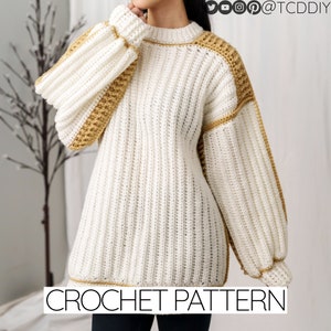 May include: A white crochet sweater with brown accents. The sweater has a round neckline and long sleeves. The sweater is a crochet pattern.