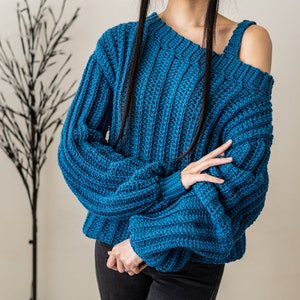 TCDDIY crochet pattern for a single strap sweater dress featuring balloon sleeves and a customizable length, crafted using Caron One Pound yarn in Ocean.