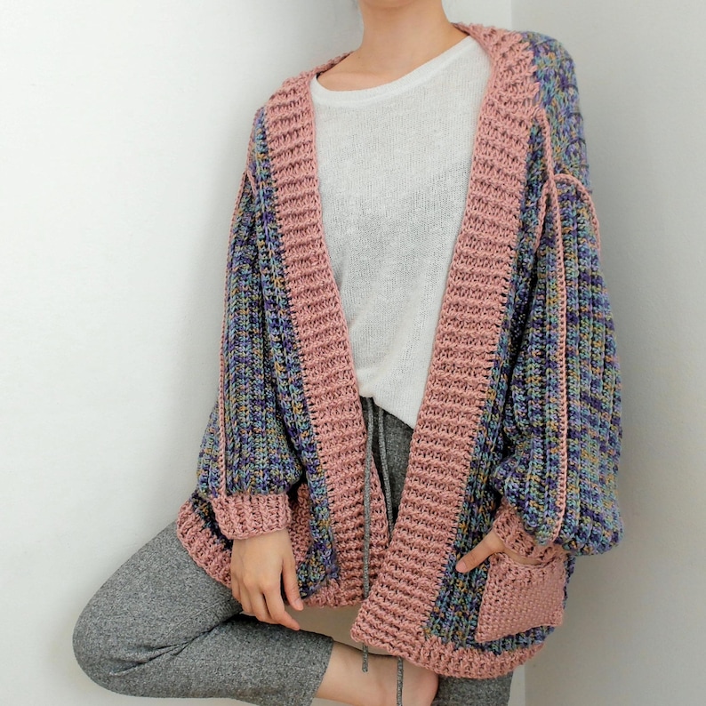 TCDDIY crochet pattern for an Oversized Reversible Cardigan featuring a ribbed two-toned design and pockets.