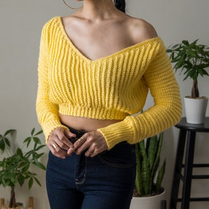 TCDDIY crochet pattern for a cropped off-the-shoulder V-neck sweater with versatile styling options, made with Lion Brand Pound of Love yarn in Honey Bee.