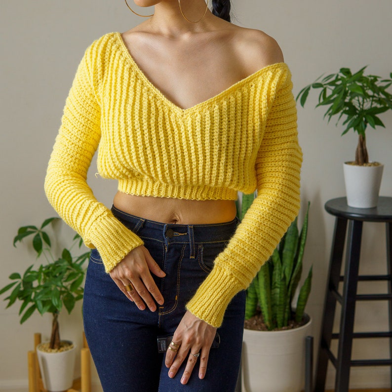 TCDDIY crochet pattern for a cropped off-the-shoulder V-neck sweater with versatile styling options, made with Lion Brand Pound of Love yarn in Honey Bee.