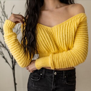 TCDDIY crochet pattern for a cropped off-the-shoulder V-neck sweater with versatile styling options, made with Lion Brand Pound of Love yarn in Honey Bee.