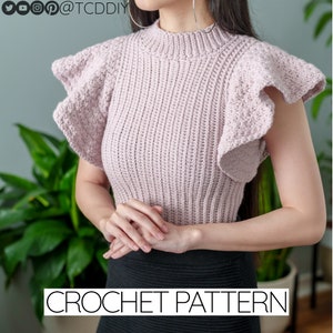 May include: A crochet pattern for a pink top with ruffled sleeves. The top is shown on a model with a black skirt. The text "CROCHET PATTERN" is visible at the bottom of the image.