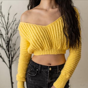TCDDIY crochet pattern for a cropped off-the-shoulder V-neck sweater with versatile styling options, made with Lion Brand Pound of Love yarn in Honey Bee.