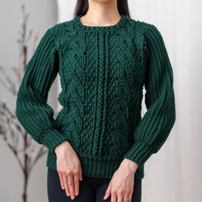 TCDDIY crochet pattern for a classic cropped crewneck sweater featuring cable and alpine stitches with ribbing details, made using Big Twist Soft yarn in Hunter Green.