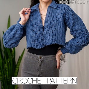 May include: A blue crochet cardigan with a collar and long sleeves. The cardigan is cropped and has a woven stitch pattern. The text "CROCHET PATTERN" is at the bottom of the image.