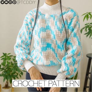 May include: A crochet pattern for a blue and white jumper with a high neck and long sleeves. The jumper has a textured design and is perfect for a winter day.