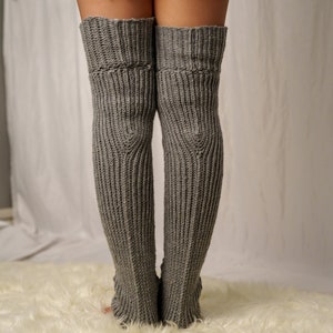 TCDDIY crochet pattern for Cable Stitch Leg Warmers featuring Alpine stitch detail and a knee-high fit, crafted using Caron One Pound yarn in Soft Grey Mix, back view.