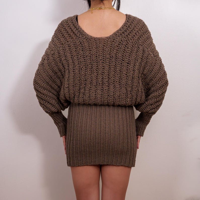 TCDDIY crochet pattern for a batwing wrap sweater dress with ribbed cuffs and fitted skirt, crafted with Lion Brand Pound of Love in Taupe, back view.