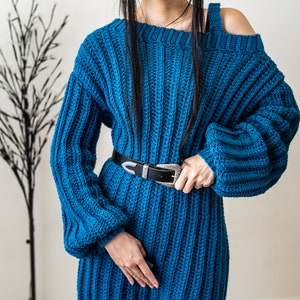 TCDDIY crochet pattern for a single strap sweater dress featuring balloon sleeves and a customizable length, crafted using Caron One Pound yarn in Ocean.
