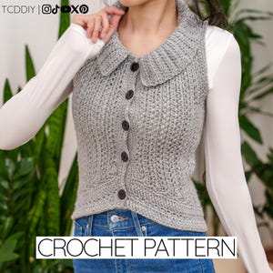 May include: A grey crochet vest with a collar and button fastening. The vest is worn over a white long-sleeved shirt and blue jeans. The text "CROCHET PATTERN" is displayed at the bottom of the image.