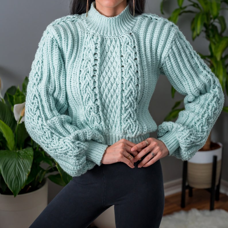 TCDDIY crochet pattern for a cropped cable stitch sweater with a mock neck and alpine stitch detailing, crafted using Caron One Pound yarn in Pale Green.
