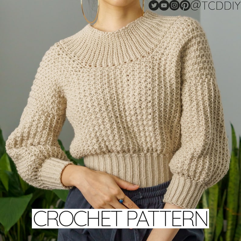 TCDDIY crochet pattern for a modern wide-collar Trinity stitch 3/4 sleeve sweater with a customizable fit, crafted using Baby Bernat Sport yarn in Baby Taupe.