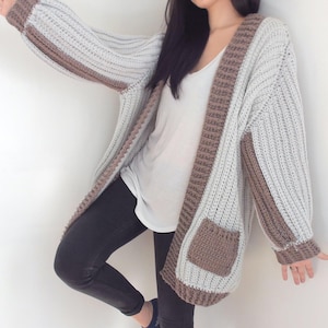 TCDDIY crochet pattern for an Oversized Reversible Cardigan featuring a ribbed two-toned design, pockets, crafted using Lion Brand Pound of Love yarn in Elephant Grey and Taupe.