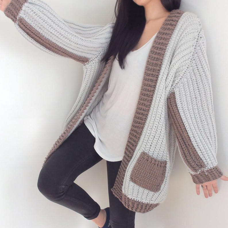 TCDDIY crochet pattern for an Oversized Reversible Cardigan featuring a ribbed two-toned design, pockets, crafted using Lion Brand Pound of Love yarn in Elephant Grey and Taupe.