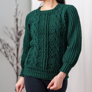 TCDDIY crochet pattern for a classic cropped crewneck sweater featuring cable and alpine stitches with ribbing details, made using Big Twist Soft yarn in Hunter Green.