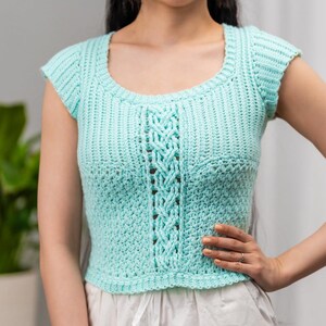 TCDDIY crochet pattern for a short sleeve cable stitch top with ribbing, featuring a cozy Suzette stitch texture, made using Lion Brand Pound of Love yarn in Pastel Green.