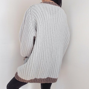 TCDDIY crochet pattern for an Oversized Reversible Cardigan featuring ribbing and pockets, crafted using Lion Brand Pound of Love yarn in Elephant Grey and Taupe, back view.