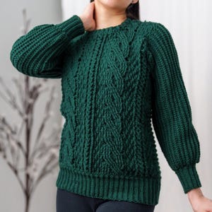 TCDDIY crochet pattern for a classic cropped crewneck sweater featuring cable and alpine stitches with ribbing details, made using Big Twist Soft yarn in Hunter Green.